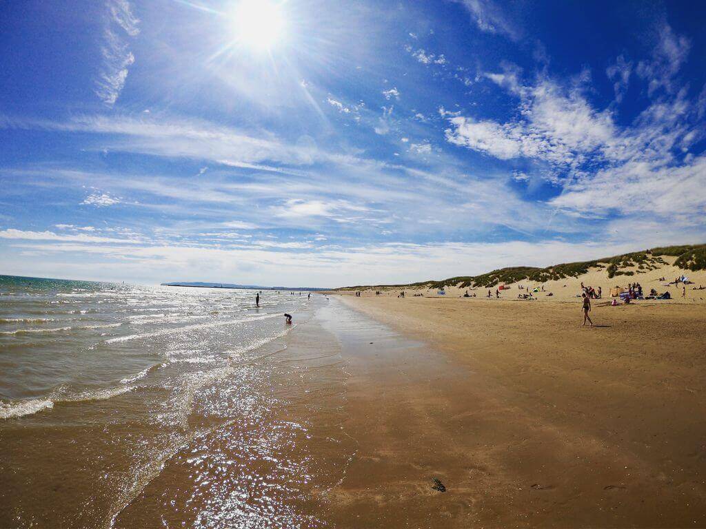 Sun and surf on the beach in Camber Sands in springtime