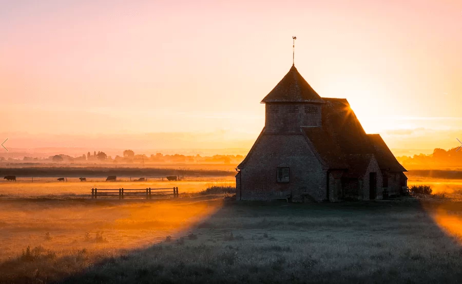autumn misty sun rise over church
