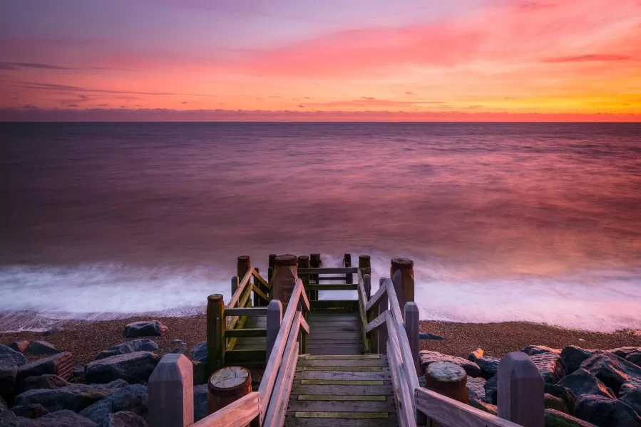 sunset over beach steps at Coastguards Cottages Camber